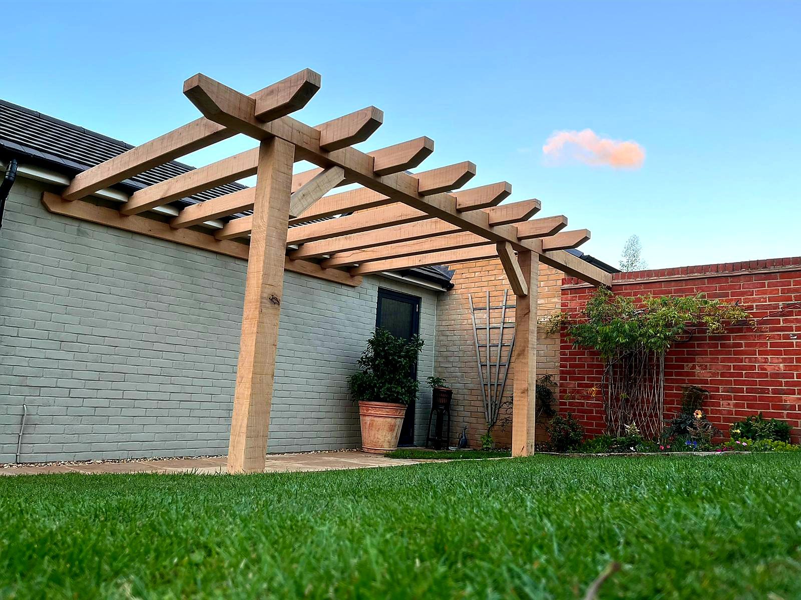 Oak pergola integrated with a garden setting